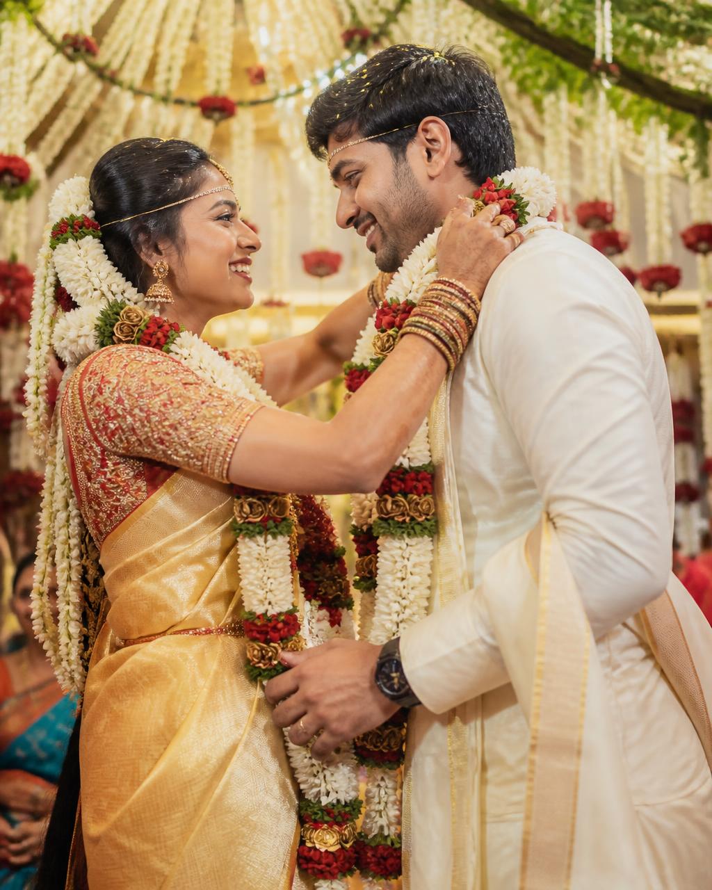 Bride and groom exchanging garlands